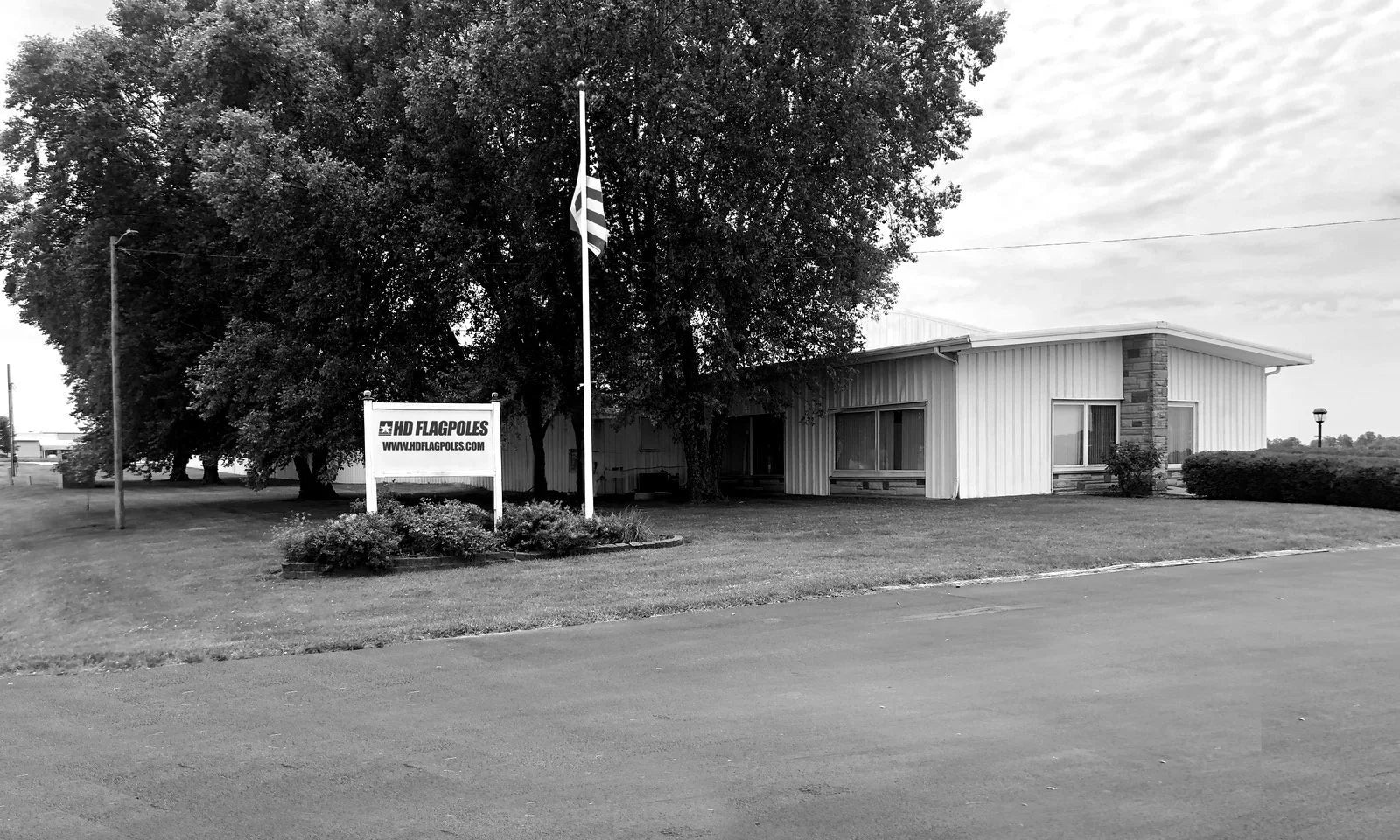 HD Flagpoles headquarters with the American flag flying out front