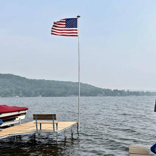 Clear Liberty Telescoping Flagpole on a lake dock
